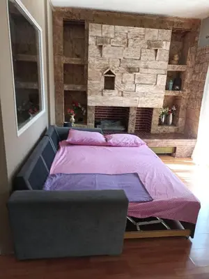 a bed in a bedroom with a brick wall at Penth3 in Athens