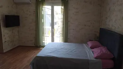 a bedroom with a bed in a room with a window at Penth3 in Athens