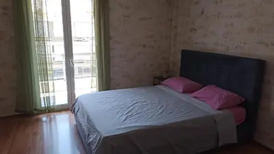 a bedroom with a bed with purple pillows on it at Penth3 in Athens