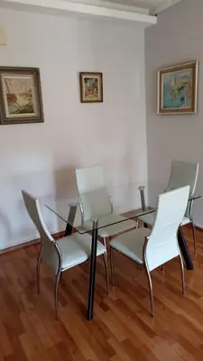 a dining room with a glass table and chairs at Penth3 in Athens