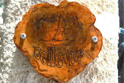 a wooden heart shaped sign on a wall at Thenia's Bellevue apartment in Saronida