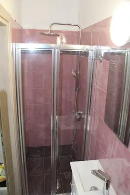 a bathroom with a shower and a sink at Thenia's Bellevue apartment in Saronida