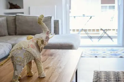 a toy elephant standing on a table in a living room at Zen Spring, Neapoli in Athens