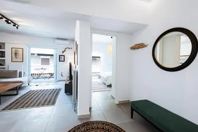 a living room with a mirror and a couch at Zen Spring, Neapoli in Athens