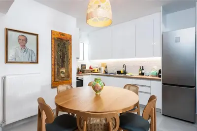 a kitchen with a wooden table and a refrigerator at Zen Spring, Neapoli in Athens