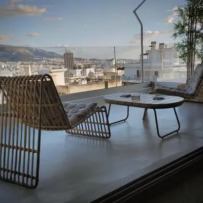 a patio with a table and chairs on a roof at Boutique Loft Penthouse in Athens