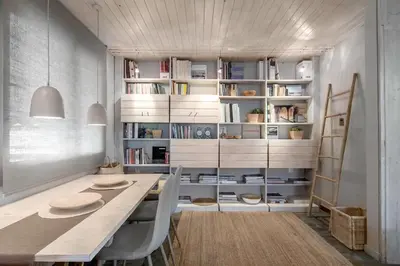 a dining room with a table and chairs and bookshelves at Boutique Loft Penthouse in Athens