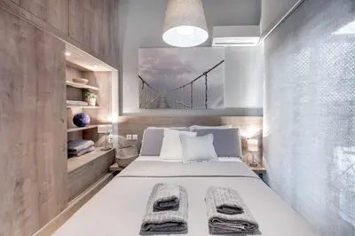 a bedroom with a bed with a bridge painting on the wall at Boutique Loft Penthouse in Athens