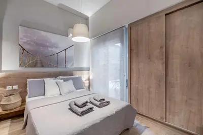 a bedroom with a large bed with towels on it at Boutique Loft Penthouse in Athens