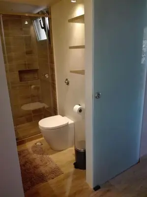 a bathroom with a toilet and a glass shower at Boutique Loft Penthouse in Athens