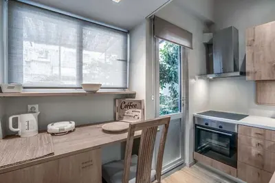 a kitchen with a counter and a table and a window at Boutique Loft Penthouse in Athens