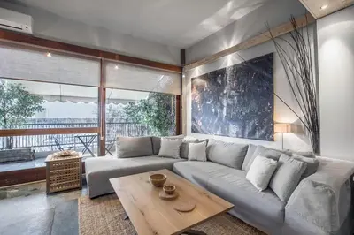 a living room with a couch and a table at Boutique Loft Penthouse in Athens