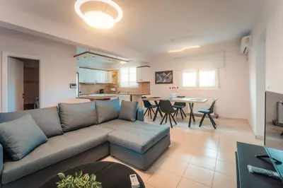 a living room with a couch and a table at Aegean escape house in Artemida