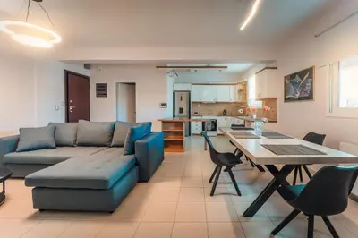 a living room with a couch and a table at Aegean escape house in Artemida
