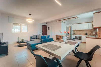 a kitchen and a living room with a table and chairs at Aegean escape house in Artemida