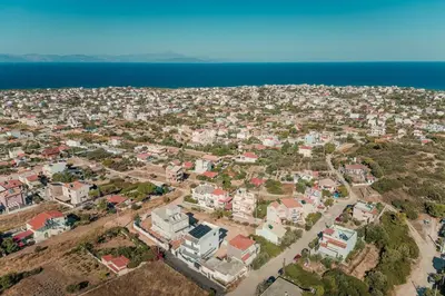 an aerial view of a city next to the ocean at Aegean escape house in Artemida