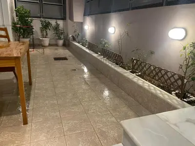 a room with a table and plants on a wall at Aegean escape house in Artemida
