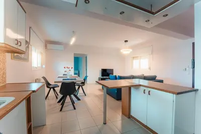 a kitchen and living room with a table and chairs at Aegean escape house in Artemida