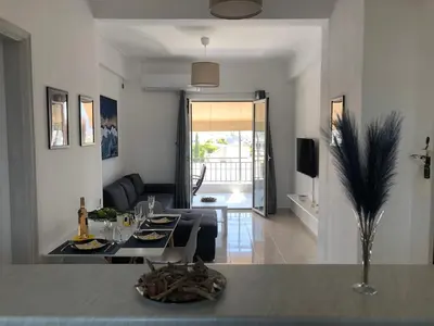 a living room with a table and a couch at Are You Renti in Piraeus