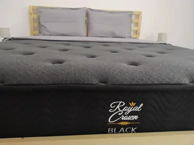 a bed with a black mattress with the words royal crown black at Are You Renti in Piraeus