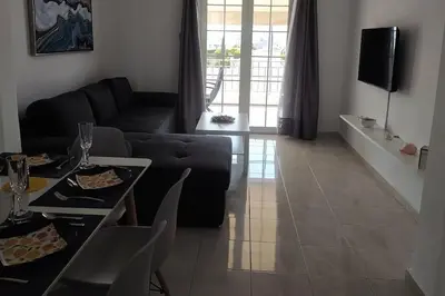 a living room with a couch and a table at Are You Renti in Piraeus