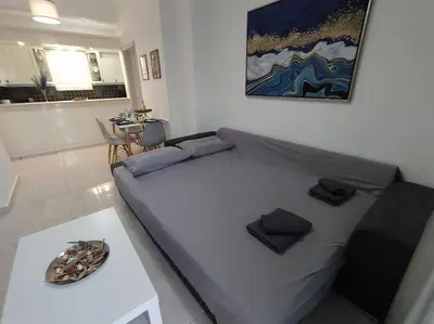 a bedroom with a bed and a table in a room at Are You Renti in Piraeus