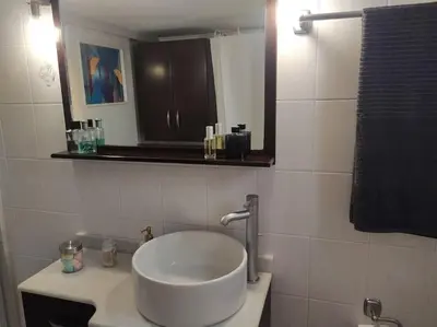 a bathroom with a sink and a mirror at Are You Renti in Piraeus