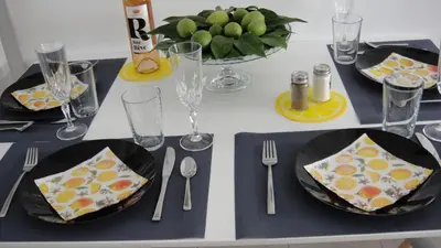a table with plates and utensils on a table at Are You Renti in Piraeus