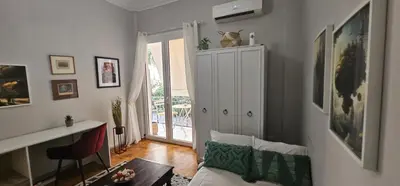 a living room with a cat sitting on top of a cabinet at Cozy and quiet apartment , convenient location in Athens in Athens