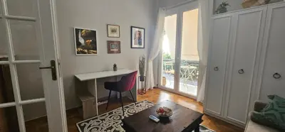 a living room with a desk and a table at Cozy and quiet apartment , convenient location in Athens in Athens