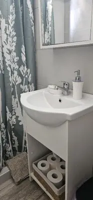 a bathroom with a sink and a shower curtain at Cozy and quiet apartment , convenient location in Athens in Athens