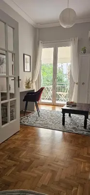 a living room with a piano and a table at Cozy and quiet apartment , convenient location in Athens in Athens