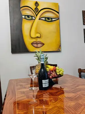 a bottle of wine and a bowl of fruit on a table at Art Interior Apartment in Athens next to Metro Stations & All Hospitals in Athens