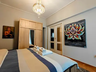 a bedroom with a bed and a chandelier at Art Interior Apartment in Athens next to Metro Stations & All Hospitals in Athens