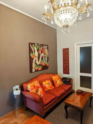 a living room with a couch and a chandelier at Art Interior Apartment in Athens next to Metro Stations & All Hospitals in Athens