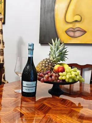 a bottle of wine and a bowl of fruit on a table at Art Interior Apartment in Athens next to Metro Stations & All Hospitals in Athens