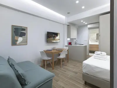 a bedroom with a bed and a table with chairs at Chic and modern apartment in the center of Kolonaki in Athens