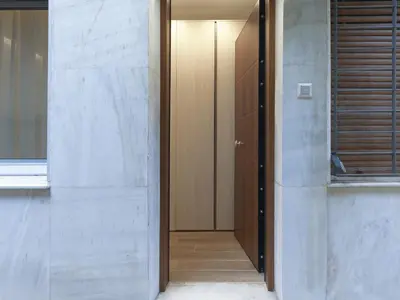 a hallway with a door leading into a room at Chic and modern apartment in the center of Kolonaki in Athens