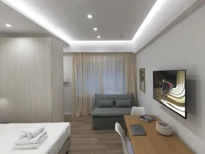 a bedroom with a bed and a table and a couch at Chic and modern apartment in the center of Kolonaki in Athens