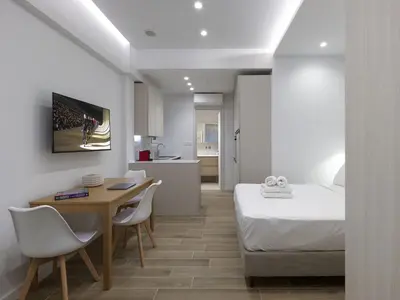 a bedroom with a bed and a table and chairs at Chic and modern apartment in the center of Kolonaki in Athens