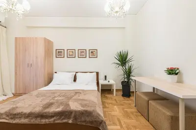 a bedroom with a bed and a table and a desk at Home 7 Minutes Away From Stavros Niarhos in Athens