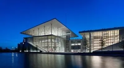 a large glass building with a blue sky in the background at Home 7 Minutes Away From Stavros Niarhos in Athens