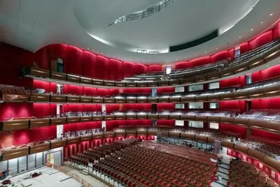 an empty auditorium with red seats in a theatre at Home 7 Minutes Away From Stavros Niarhos in Athens