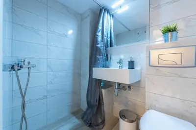 a bathroom with a sink and a shower at Home 7 Minutes Away From Stavros Niarhos in Athens