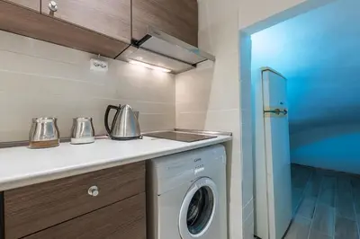 a kitchen with a washer and dryer on a counter at Home 7 Minutes Away From Stavros Niarhos in Athens