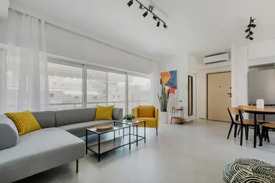 a living room with a couch and a table at A Place 4U 20, 2 Bedrooms & 2 Bathrooms with view of Acropolis in Athens