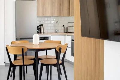 a kitchen with a wooden table and four chairs at A Place 4U 20, 2 Bedrooms & 2 Bathrooms with view of Acropolis in Athens