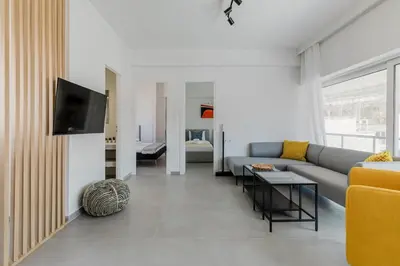 a living room with a couch and a tv at A Place 4U 20, 2 Bedrooms & 2 Bathrooms with view of Acropolis in Athens