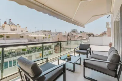 a balcony with chairs and a view of a city at A Place 4U 20, 2 Bedrooms & 2 Bathrooms with view of Acropolis in Athens