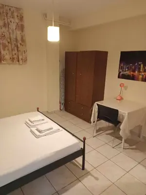 a bedroom with a bed and a table and a desk at Athens Koukaki - Metro station Sygrou-Fix closer in Athens
